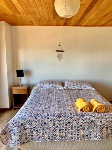 a bedroom with a bed with two pillows on it at Habitación privada, vista al mar 1 in Ancud