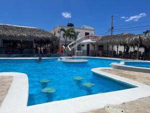 a swimming pool with a water slide in a resort at Hotel Sol Azul in La Romana