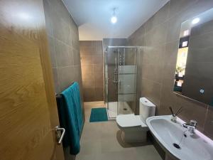 y baño con ducha, aseo y lavamanos. en Casa Teri - Los Lagos en Cotillo