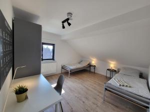 a living room with two beds and a table at MyTimeHouse in Ober-Ramstadt