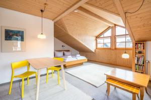 a room with a table and chairs and a bed at Haus in den Wiesen in Burgberg