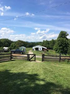 a fence with a truck parked in a field at The Ranch in Mt Airy in Mount Airy