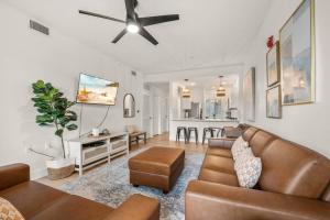 a living room with a couch and a ceiling fan at Luxurious Golf Condo W/ Resort Pool and Amenities! in Naples
