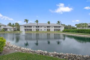 a large building with a pond in front of it at Luxurious Golf Condo W/ Resort Pool and Amenities! in Naples