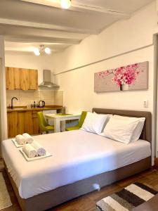 a bedroom with a bed and a kitchen at Apartments Bajkovic in Kotor