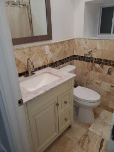 a bathroom with a sink and a toilet at Casa Bella in North Bergen