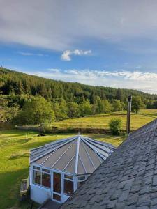 a roof of a house with a solarium on it at Self catering flat in heart of Scottish Highlands in Garve