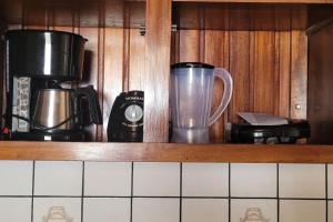 a kitchen shelf with a blender and a coffee maker at Casa ampla e aconchegante in Santarém