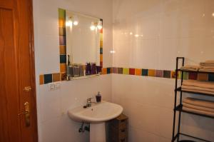 a bathroom with a sink and a mirror at Casa La Sorpresa in La Ermita del Piar +48 photos