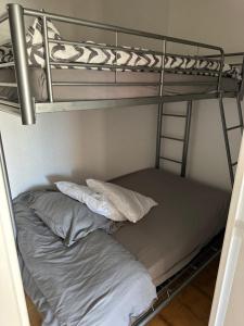 a bunk bed with two pillows on the bottom bunk at HELiOS in Cap d'Agde