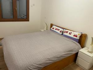 a bed with two pillows on it in a bedroom at Chalet Maillet Mieussy in Mieussy