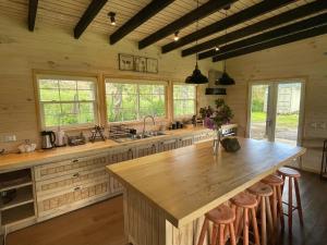 a large kitchen with a large wooden counter top at Cabaña Azul in Riñinahue