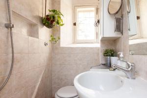 a bathroom with a sink and a toilet and a window at Vacanze Romane in Rome