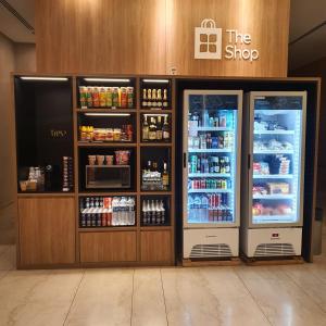 a store with two refrigerators in a store at Suite Queen Deluxe BH in Belo Horizonte