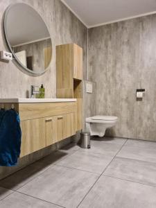 a bathroom with a sink and a mirror at Tromsø stunning Luxury apart B in Tromsø