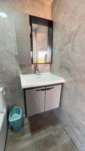 a bathroom with a sink and a mirror at Starry Domes Desert Camp II in Badīyah