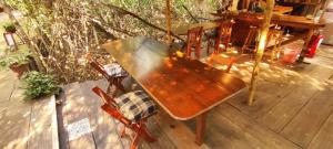 a wooden table and two chairs on a deck at Cabaña Corazon Mazunte in Mazunte