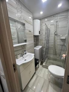 a bathroom with a sink and a toilet and a shower at Amazing location in the city center in Bucharest