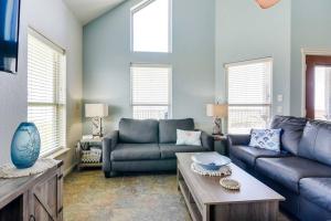 a living room with a couch and a table at 'Coastal Retreat: 'Sea Dreams Beach House' in Freeport
