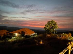 a house sitting on top of a hill at sunset at Fulora Guest House only Family Welcomed in Kolthare
