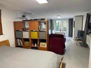 a bedroom with a bed and a book shelf at Studio renové rdc terrasse wépion (Namur) in Namur