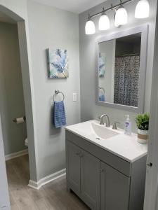 a bathroom with a sink and a mirror at Beach House in Oceanlakes Campgrounds Myrtle Beach, South Carolina in Myrtle Beach