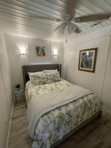 a bedroom with a bed with a ceiling fan at Beach House in Oceanlakes Campgrounds Myrtle Beach, South Carolina in Myrtle Beach