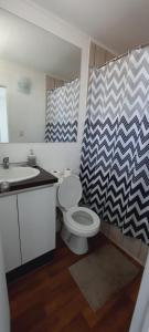 a bathroom with a toilet and a sink at Lindo departamento central in Ovalle