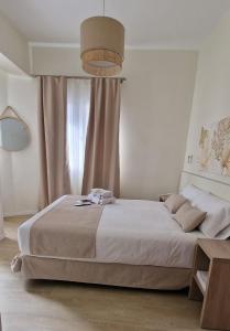 a bedroom with a large bed and a window at Le Petit Palü Las Palmas in Las Palmas de Gran Canaria
