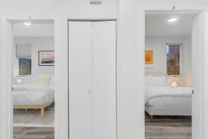 a white room with two beds and a window at Cozy Oasis in the heart of Capitol Hill in Seattle