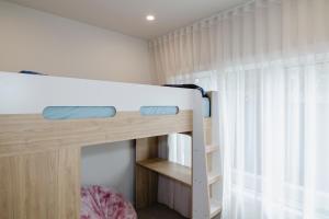 a bunk bed in a room with a window at Beachside Mornington house in Mornington