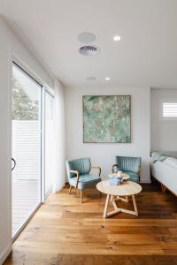 a living room with a couch and a table at Beachside Mornington house in Mornington