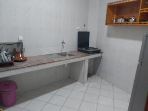 a kitchen with a counter and a sink in a room at Résidence Taghazout Oufella by Surf Times in Taghazout