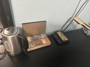 a table with a tea kettle and a box on it at Habitación con baño privado in Gáldar