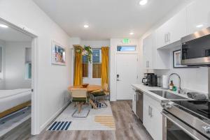 a kitchen with a sink and a table in a room at Calm Urban Abode steps to Volunteer Park in Seattle