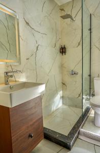 a bathroom with a sink and a shower at Rotana Pyramids View in Cairo