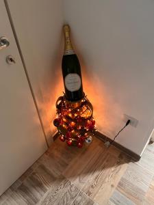 a bottle of wine sitting on top of a christmas wreath at B&B borgo Dolcecanto in Gravina in Puglia