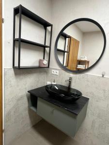 a bathroom with a black sink and a mirror at Apartment Enarina in Telfs in Telfs