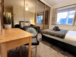 a hotel room with a bed and a table and a chair at The Tansley Gardens in Darlington