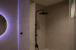 a bathroom with a shower with purple lighting at Μikri Arktos Boutique Hotel in Dhimitsana