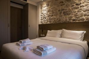a hotel room with towels on a bed at Μikri Arktos Boutique Hotel in Dhimitsana