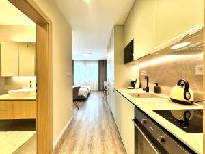 a kitchen with a sink and a counter top at Hotel Tyrapol - Smrek Apartments in Oravská Lesná