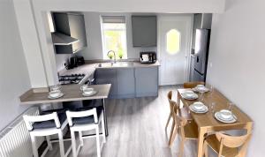 a kitchen and dining room with a table and chairs at Smithdown Rooms in Liverpool