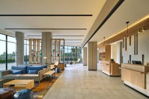a lobby of a hospital with couches and chairs at Fairfield by Marriott Jakarta Soekarno-Hatta Airport in Tangerang