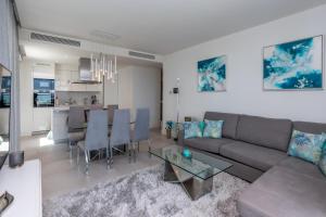 a living room with a couch and a table at Luxury 2BR Seaviews - Santa Barbara Heights in Fuengirola