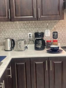 a kitchen counter top with a coffee maker on it at Zen Nest in Brampton