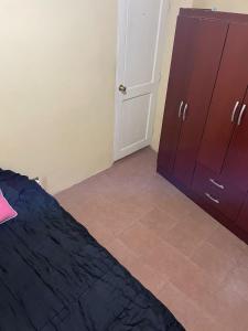 um quarto com uma cama, um armário e uma porta em Habitación en Concon y área compartida em Concón