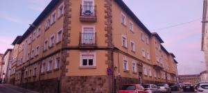 a building with cars parked in front of it at Apartamento La Luz de Reinosa 1 in Reinosa