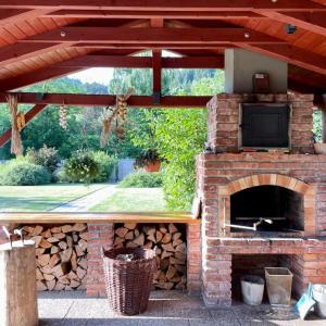 a brick fireplace with a television on top at Penzion U Bečvy in Karolinka