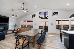 a dining room and living room with a table and chairs at Moonstone Lodge Lake Views Sleeps 28 GolfSim Pup Friendly in Branson